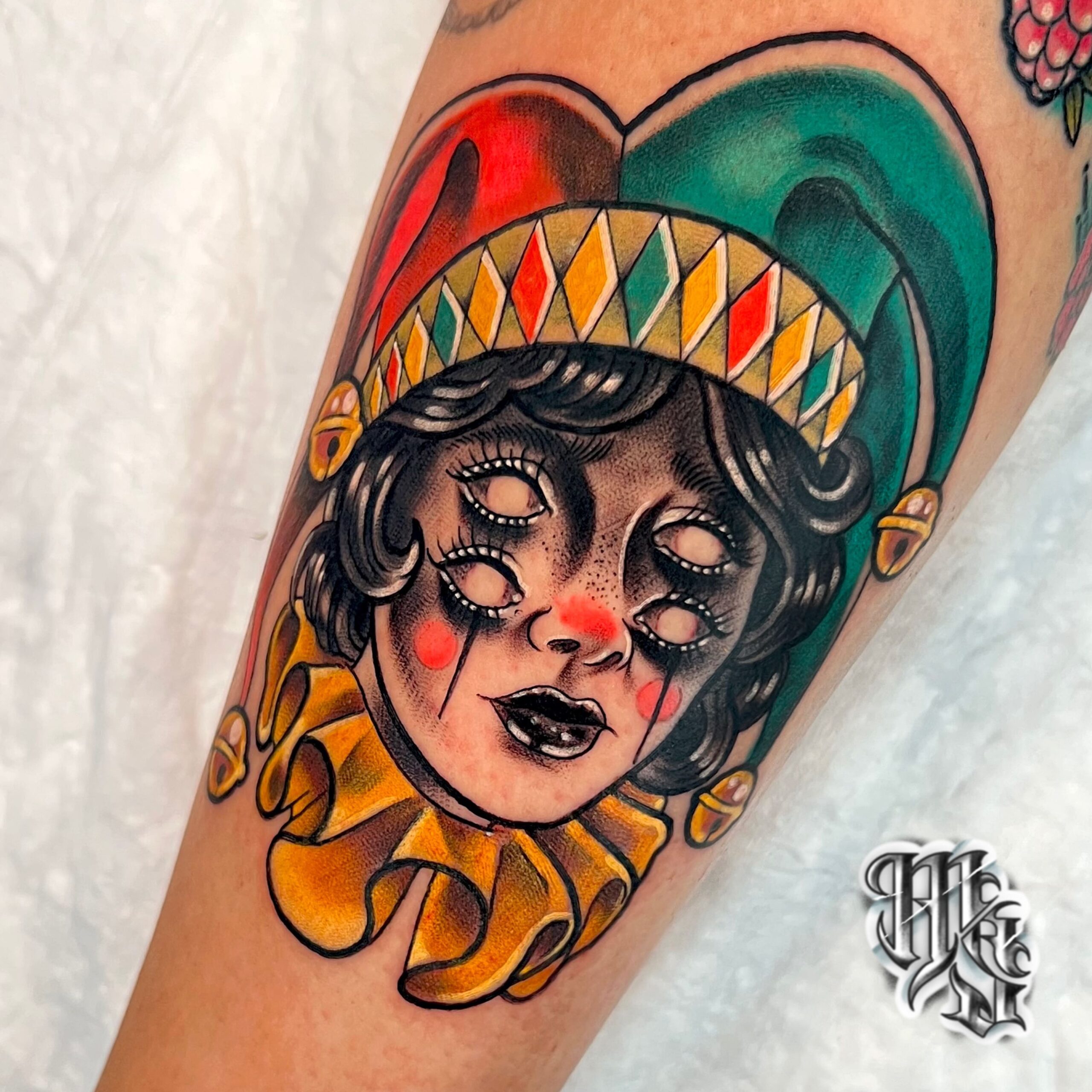Tatuaje estilo neotradicional de un arlequin en estilo dark con 4 ojos y a todo color , estudio de tatuajes en madrid