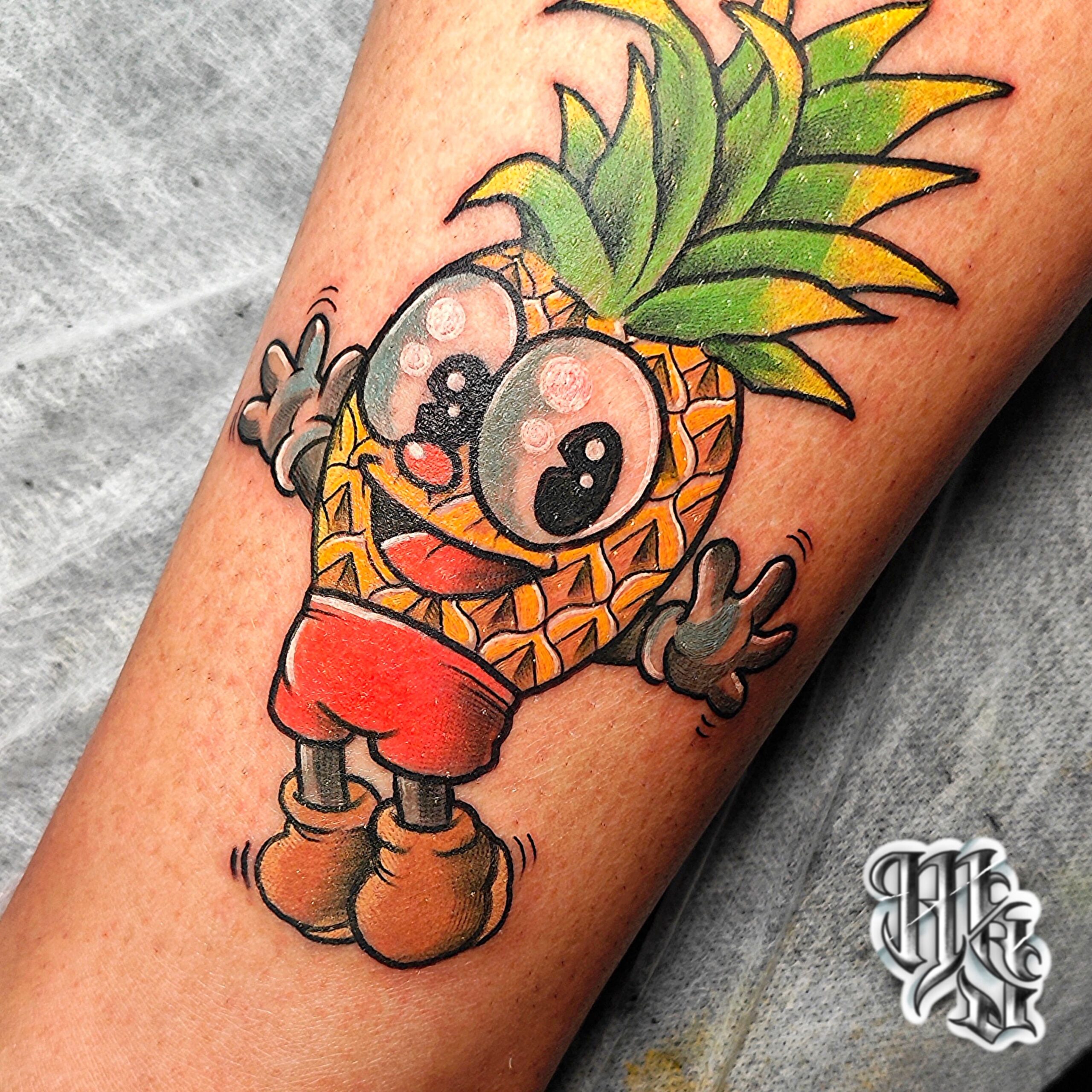 Piña en estilo newschool a todo color, con caracteristicas de los personaje de cuphead, realizado por miguel sierra tatuajes en estudio profesional en madrid